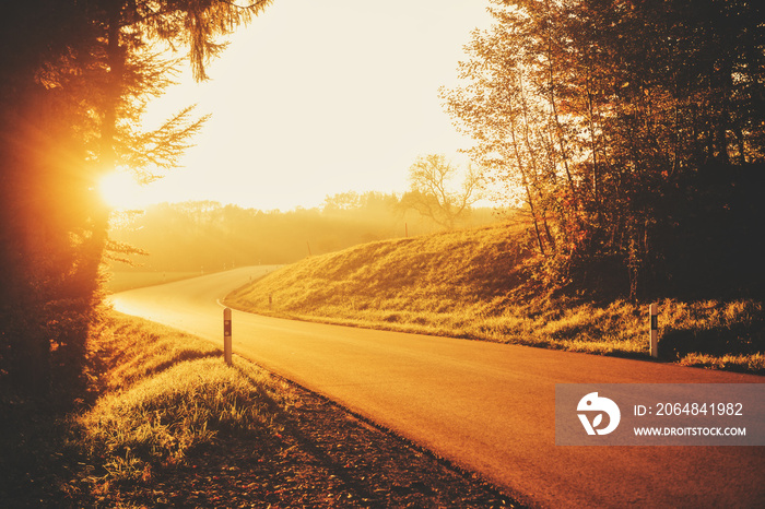 Beautiful bright sunset over small countryside road