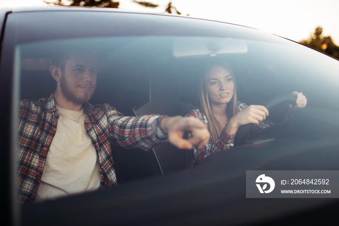 Male instructor and woman student, driving lesson