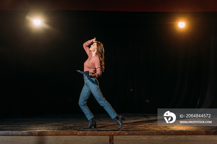 emotional young actress performing role on stage in theatre