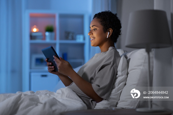 technology, internet and people concept - happy smiling young african american woman with tablet pc 