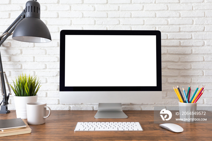 Mockup blank screen computer on a wooden desk. desktop empty white screen, with workspace and office