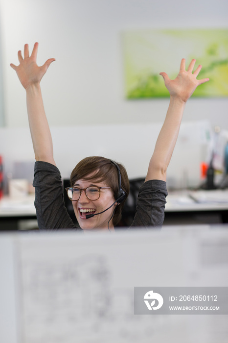 Excited businesswoman celebrating in office