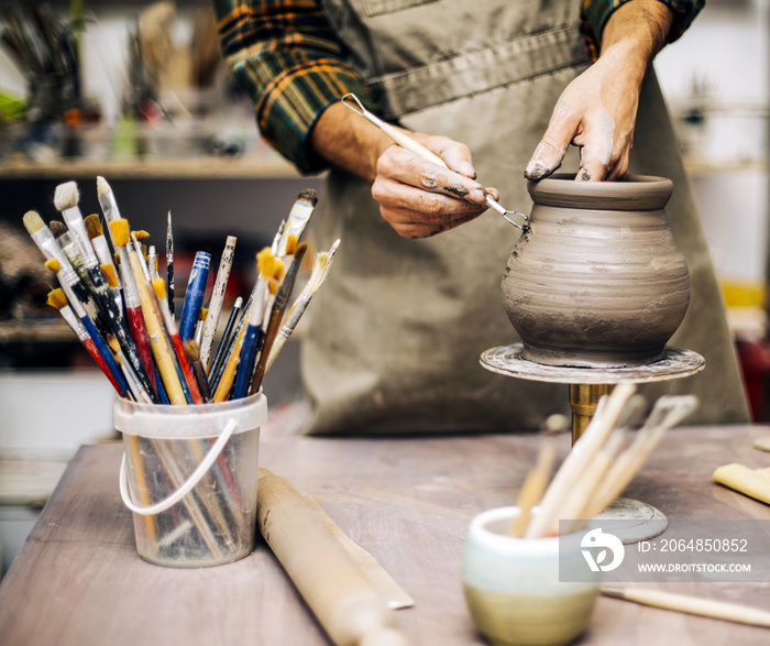 Young man making pottery in workshop