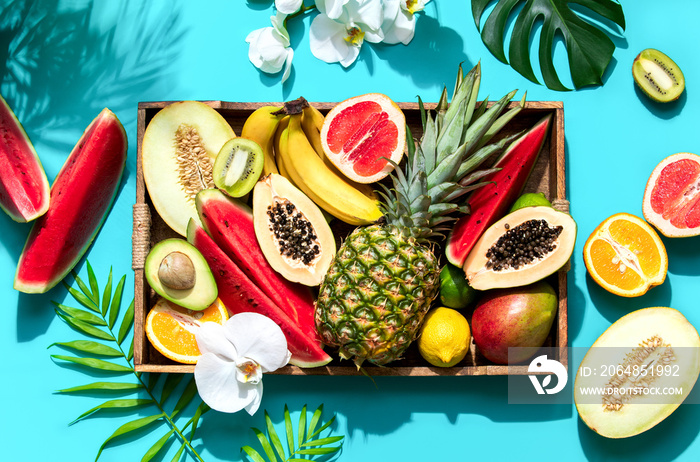 Summer healthy food concept, top down view on raw tropical fruits