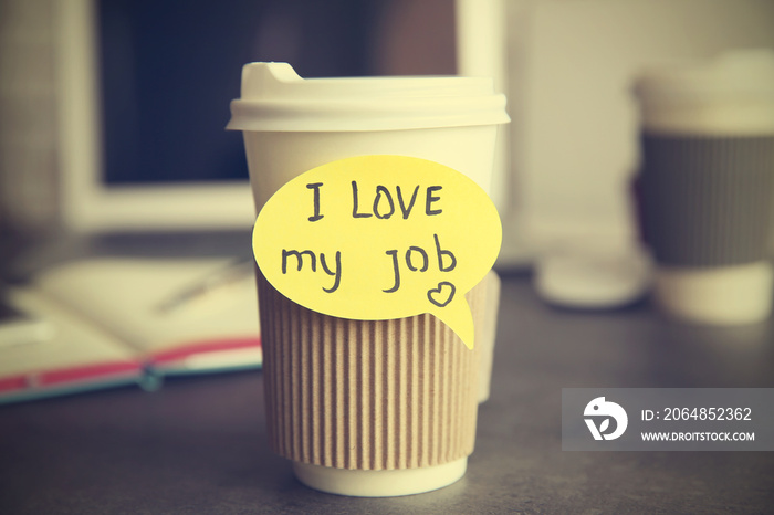 I love my job concept. Cup with hot coffee on grey table