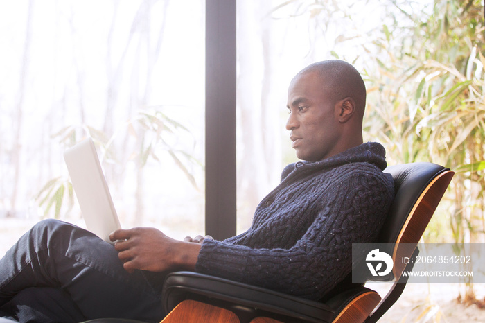 Man working on laptop in living room