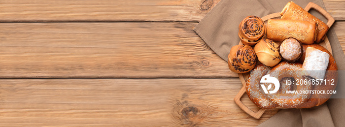 Board with tasty pastries on wooden background