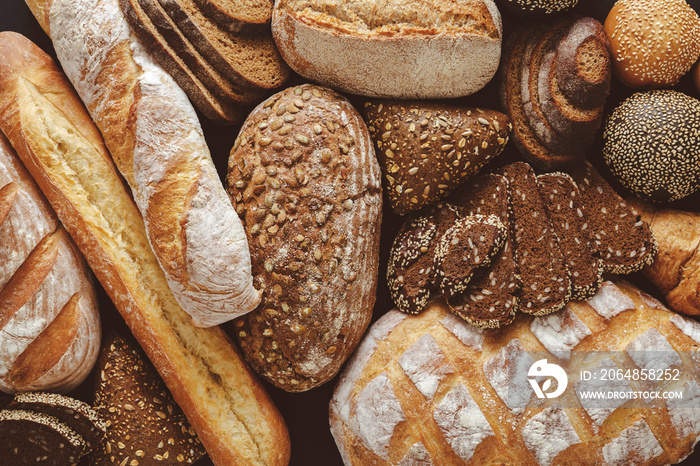 Bread background, top view of white, black and rye loaves