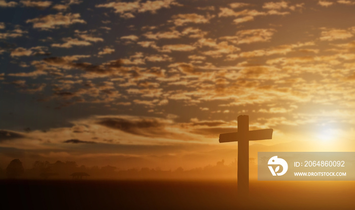 Silhouette of catholic cross at sunset background.