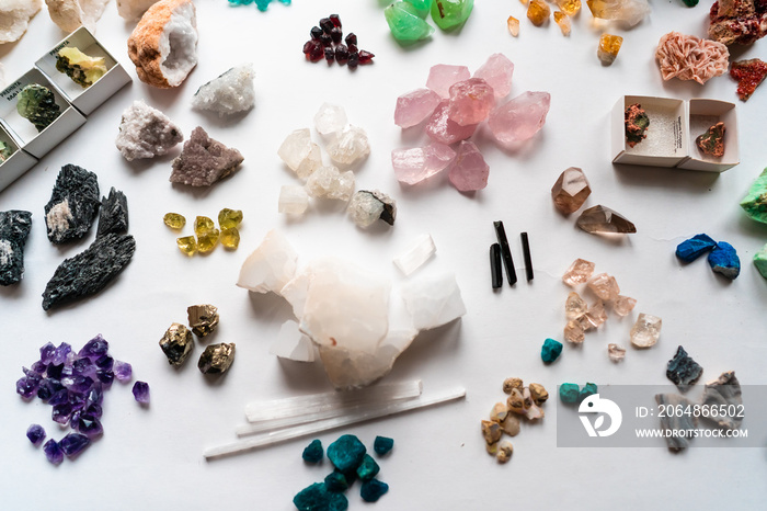 Collection of beautiful precious stones on white table.