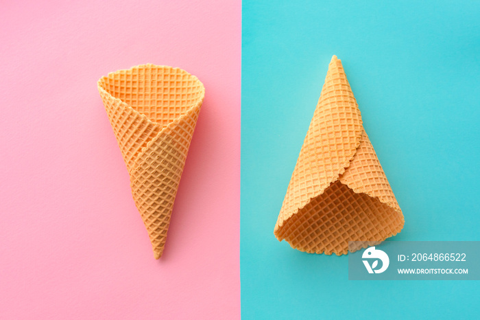 Ice cream waffle cones on pastel pink and blue background