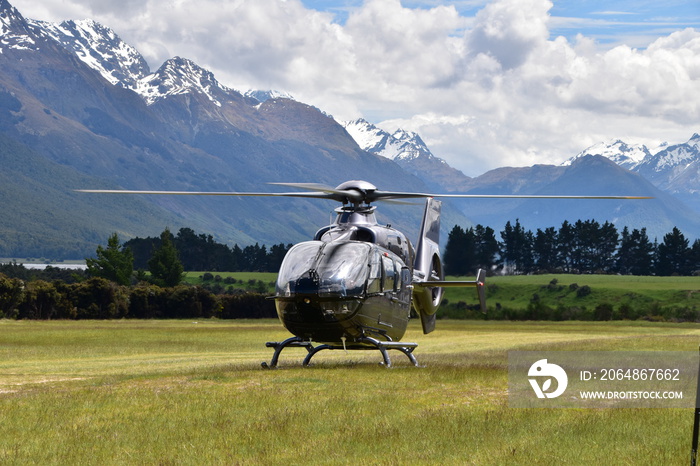 The view of mountains with a helicopter in Queenstown, New Zealand