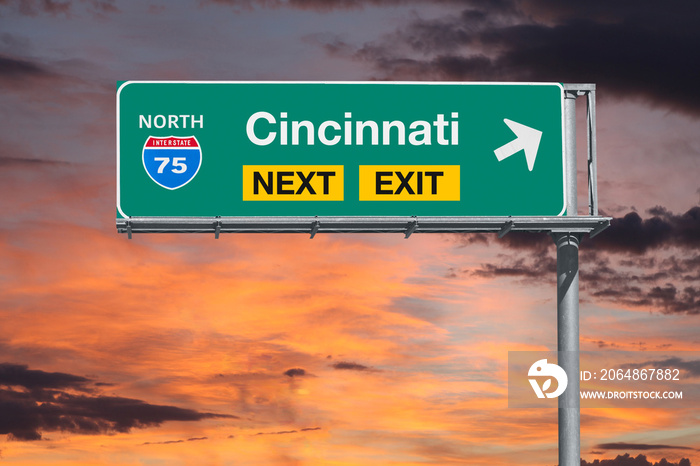 Cincinnati Ohio route 75 freeway next exit sign with sunset sky.