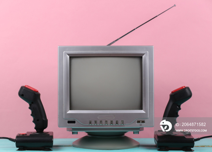 Retrogaming. Video game competition. Old TV with joysticks on pink background. Attributes 80s