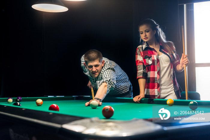 Friends playing billiard, man going shot a ball