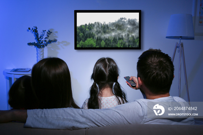 Family watching television at home. Leisure and entertainment concept.