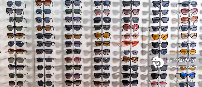 Sunglasses in a store. Showcase with spectacles in modern ophthalmic store.