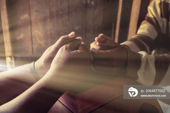 group of different men praying together, color filter added.