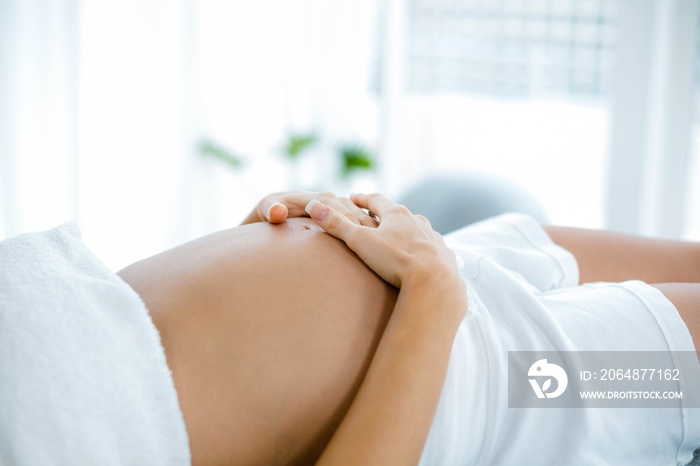 Pregnant woman relaxing on massage table