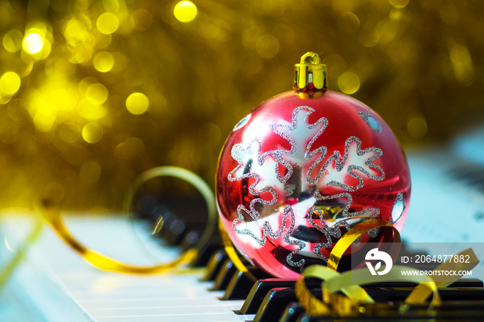 Christmas decorative ball on piano keys. Christmas music_