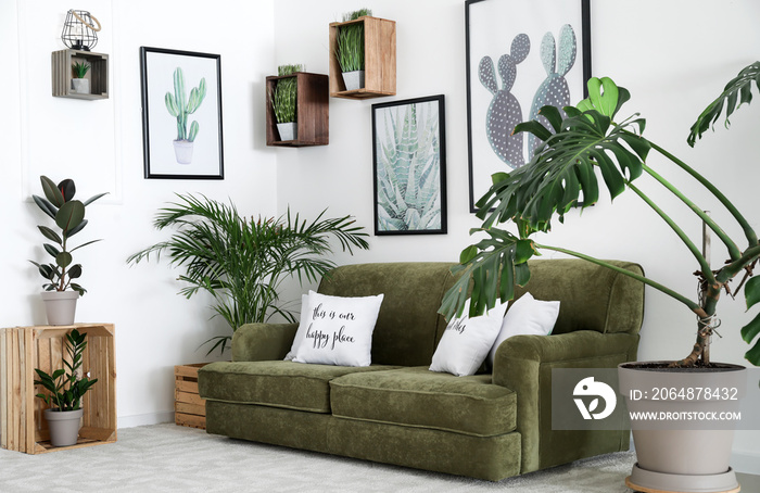 Interior of modern room with comfortable sofa and houseplants