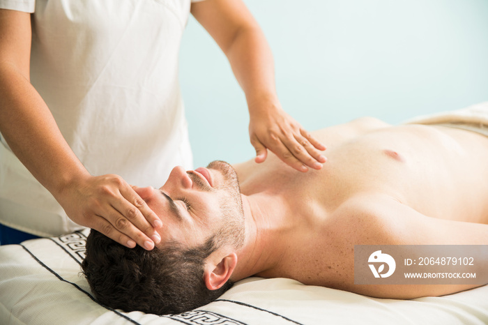 Reiki therapy on a young man