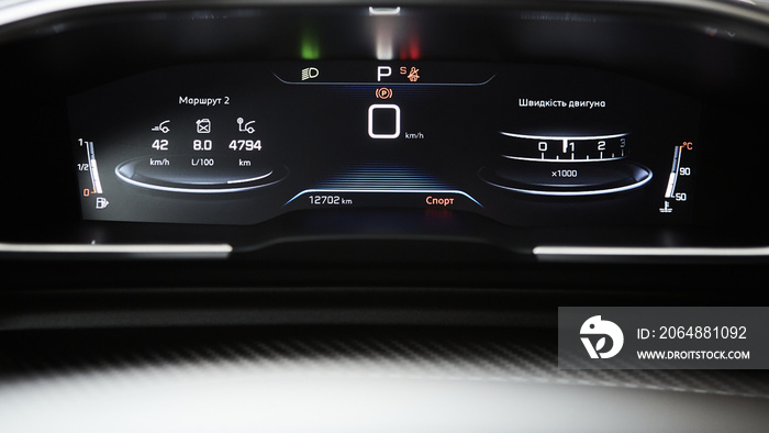 Car dashboard panel with speedometer, tachometer, odometer, fuel gauge and gear position indicator.