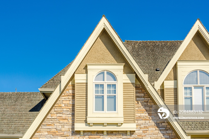 The roof of the house with nice window.