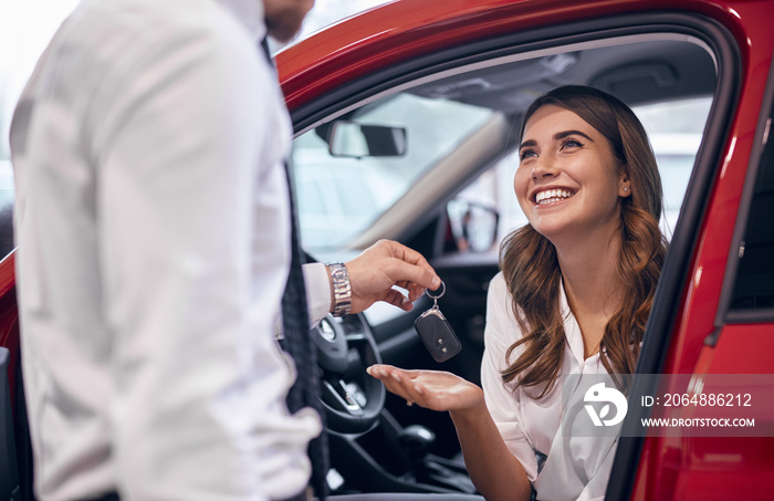 Dealer giving keys to happy customer