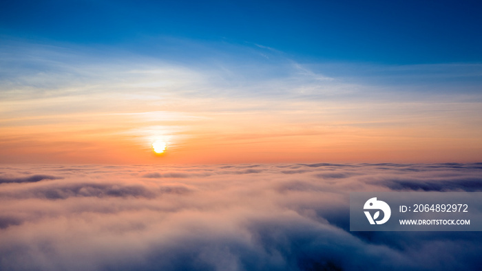 Dawn or sunset over the clouds, blue hour, aerial view.