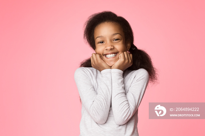 African-american girl reclining on her arms and looking at camera