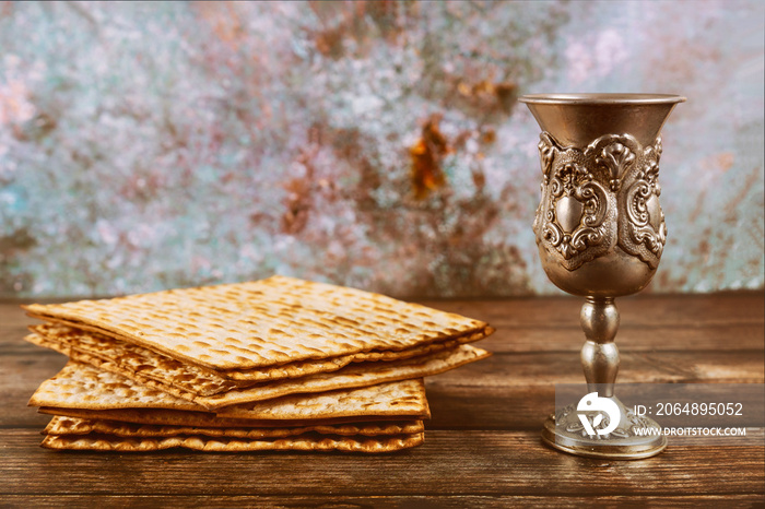 Matzos bread with kiddush cup of wine. Jewish pesah holiday.