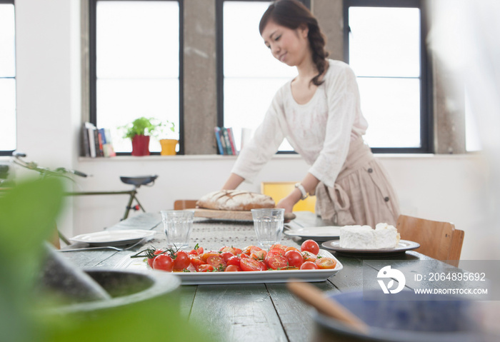 Young woman preparing lunch at table