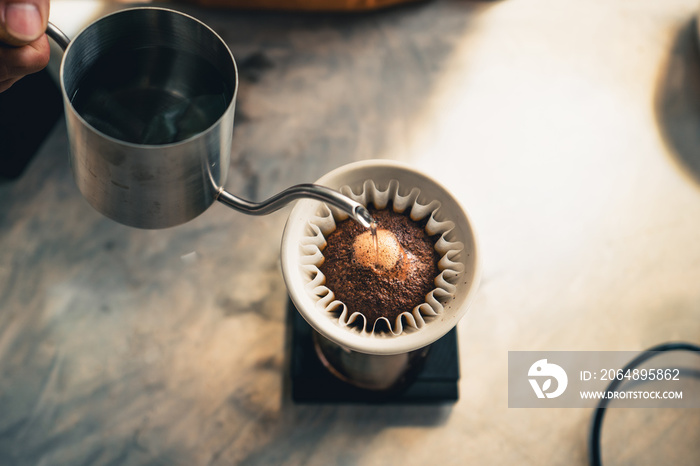 Drip coffee, barista pouring water on coffee ground with filter