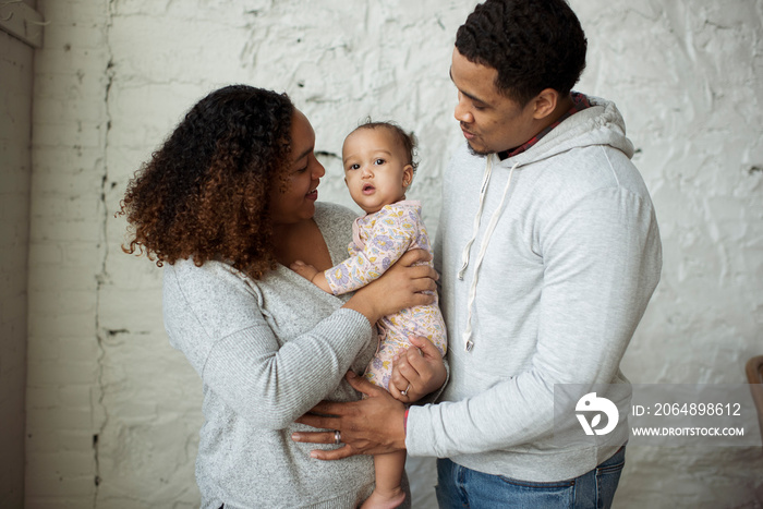 Parents with daughter standing at home