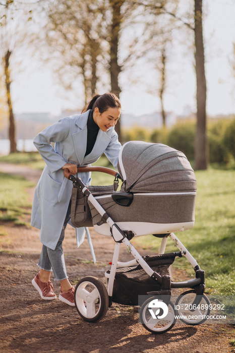 Young asian woman mother, walking with baby stroller in park