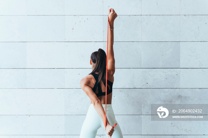 Female athlete with stretching bands.