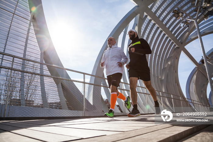 Two mature men running