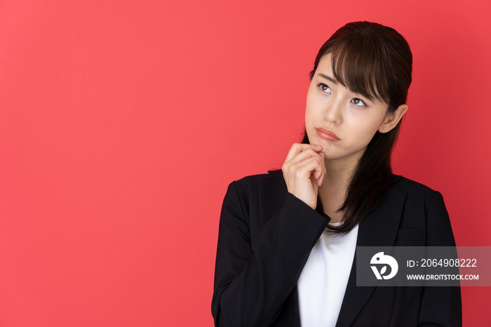 portrait of asian businesswoman isolated on red background