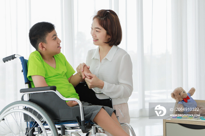 Positive multiethnic nurse and kid with cerebral palsy communicating during rehabilitation therapy