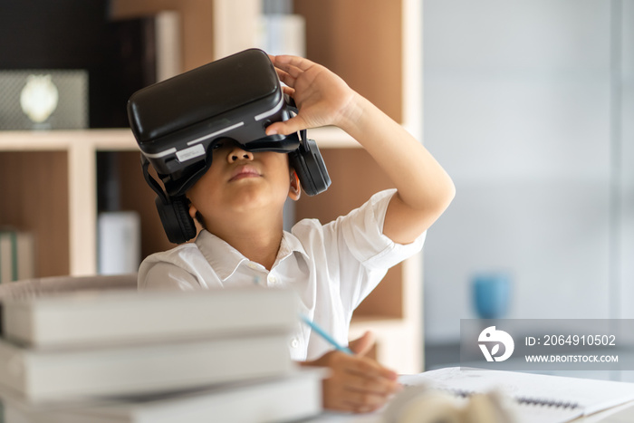 Asian boy study online with VR, virtual reality