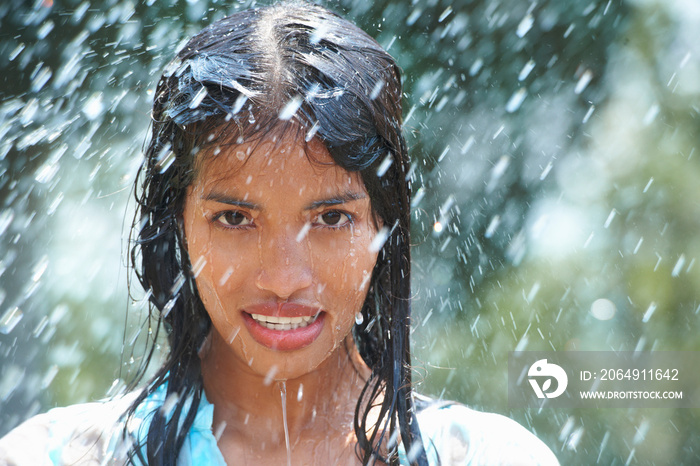 Portrait of young woman in rain