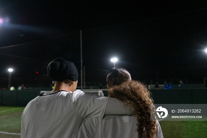 Female soccer players embracing