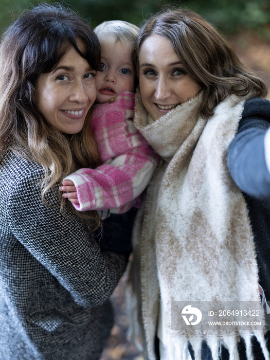 Portrait of family with baby in park�