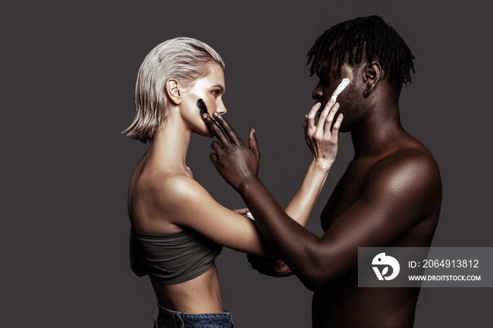 Two models with different skin colors promoting cosmetics