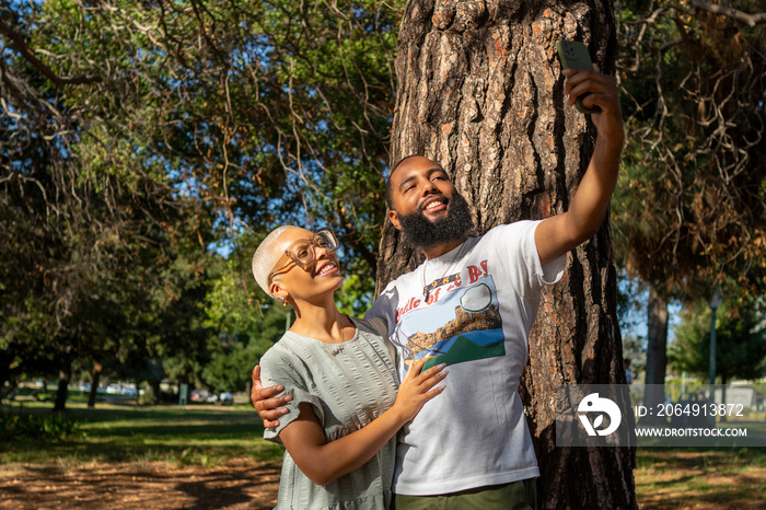 Couple taking selfie in park