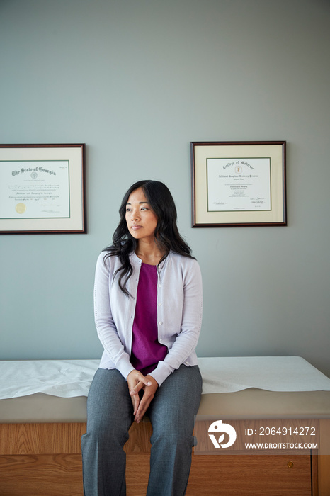 Woman waiting in examination room