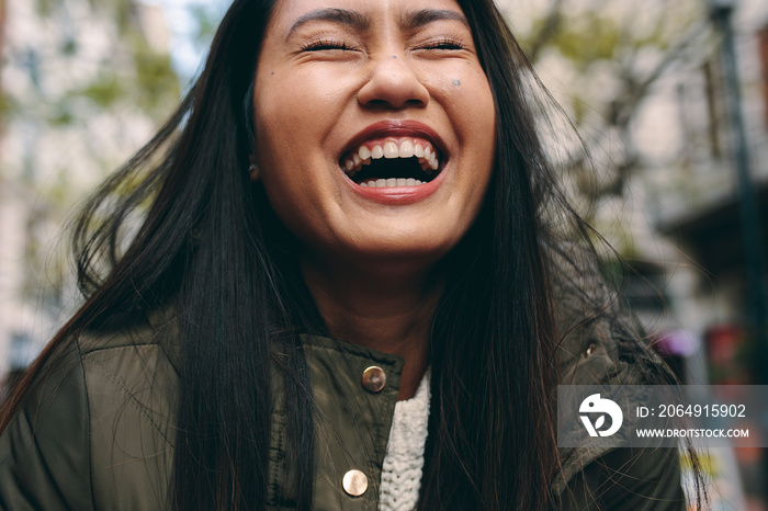 Close up of an asian woman laughing