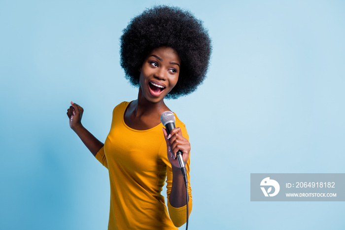 Photo portrait of pretty black skinned girl singing on microphone with wire on stage isolated on vib