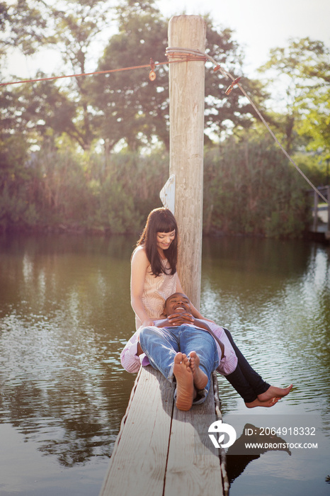 Couple relaxing on pier